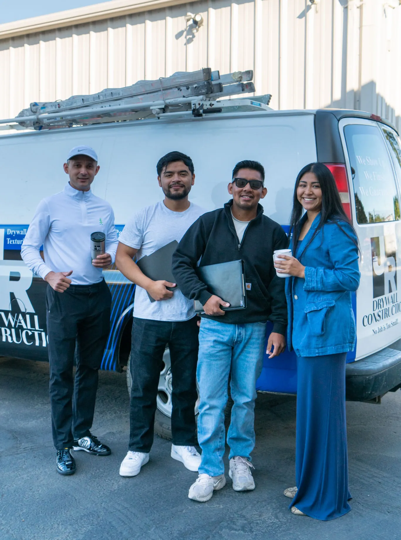 The J.R Drywall & Painting Construction LLC crew standing in front of a company van in Eugene, Oregon
