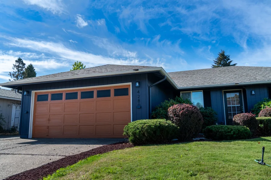 Side elevation in deep navy with white window trim
