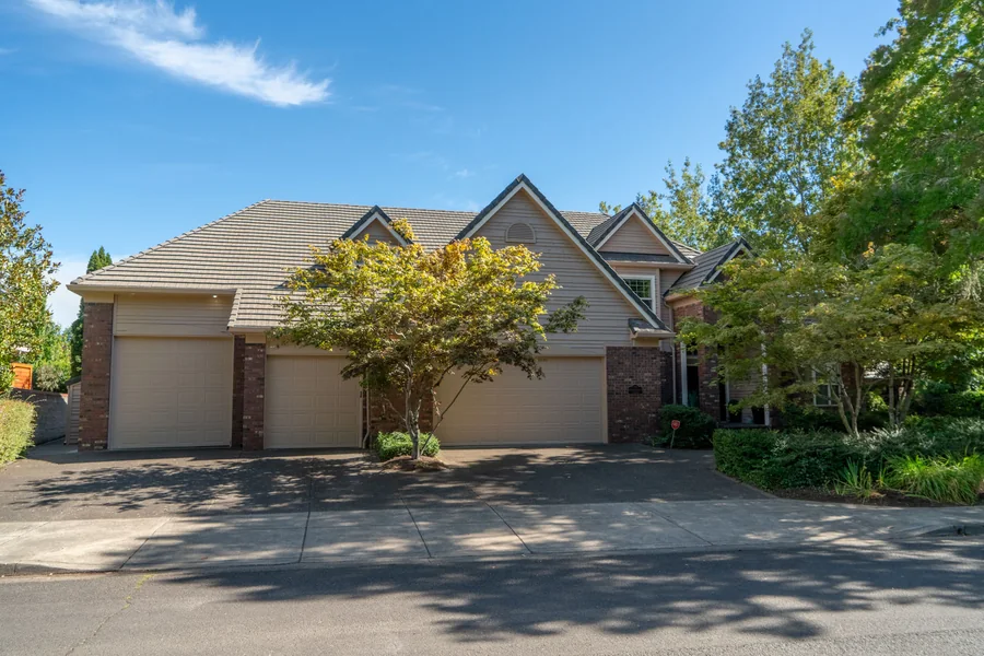 Tan lap siding and brick detailing after an exterior repaint