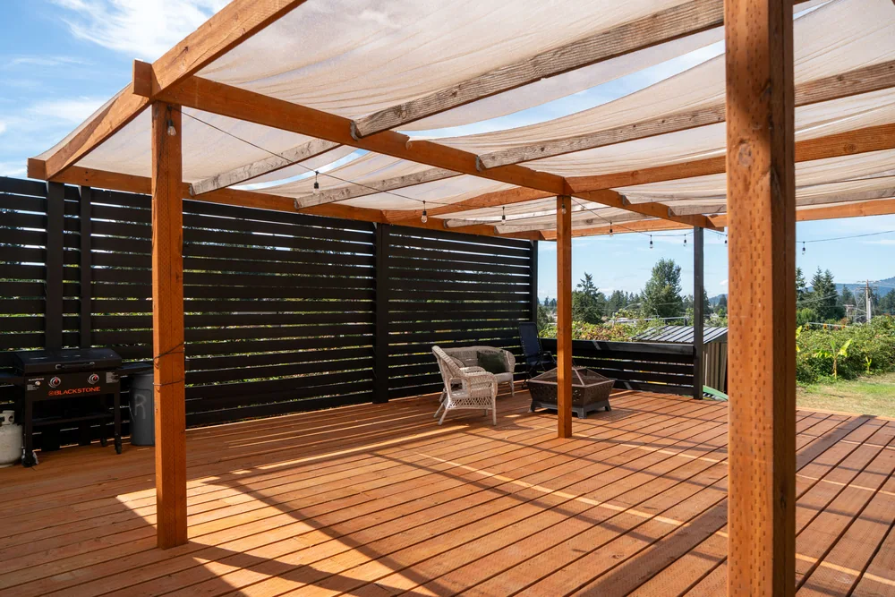 Pergola framing over a finished cedar deck