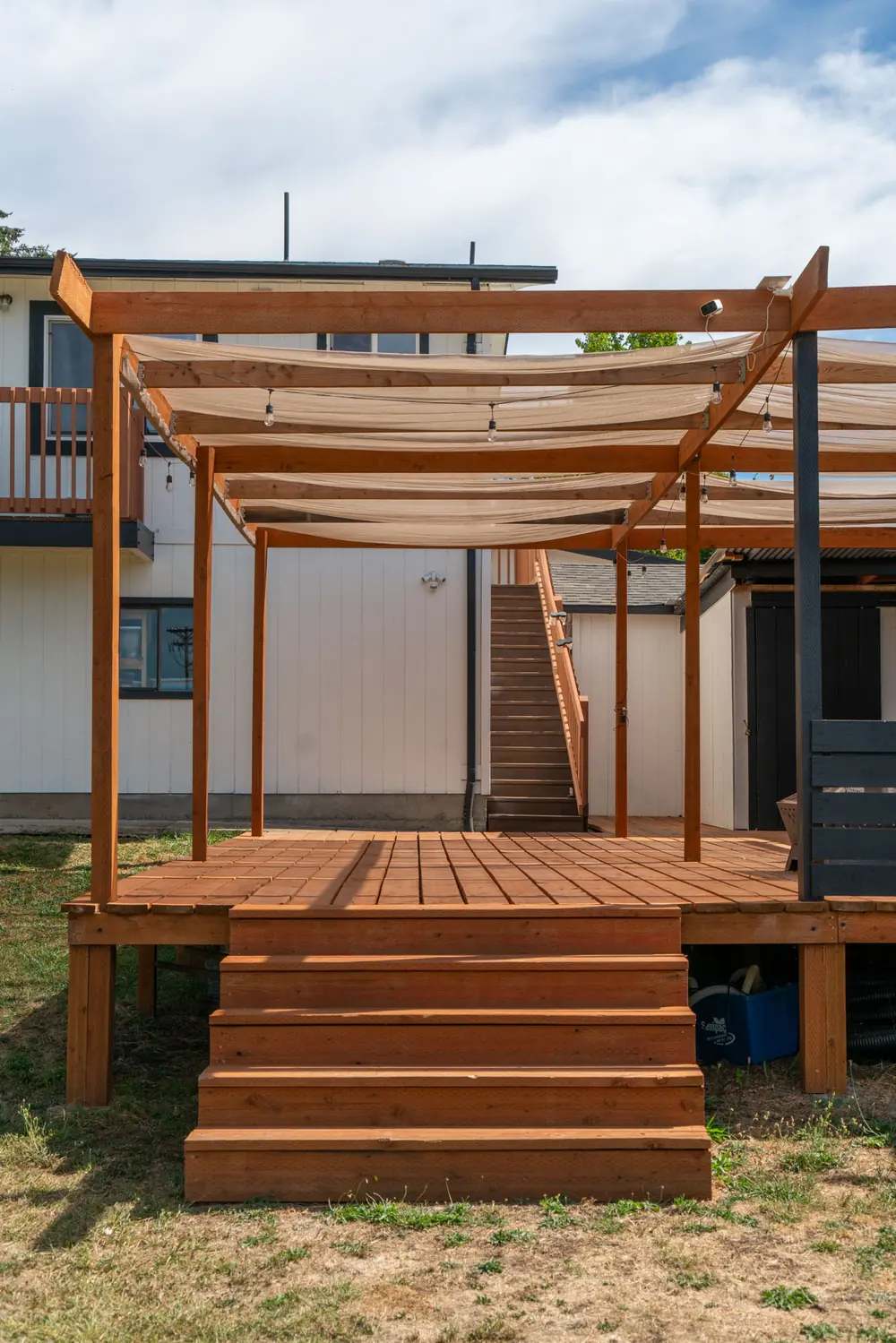Detail of pergola beams meeting the house above the deck